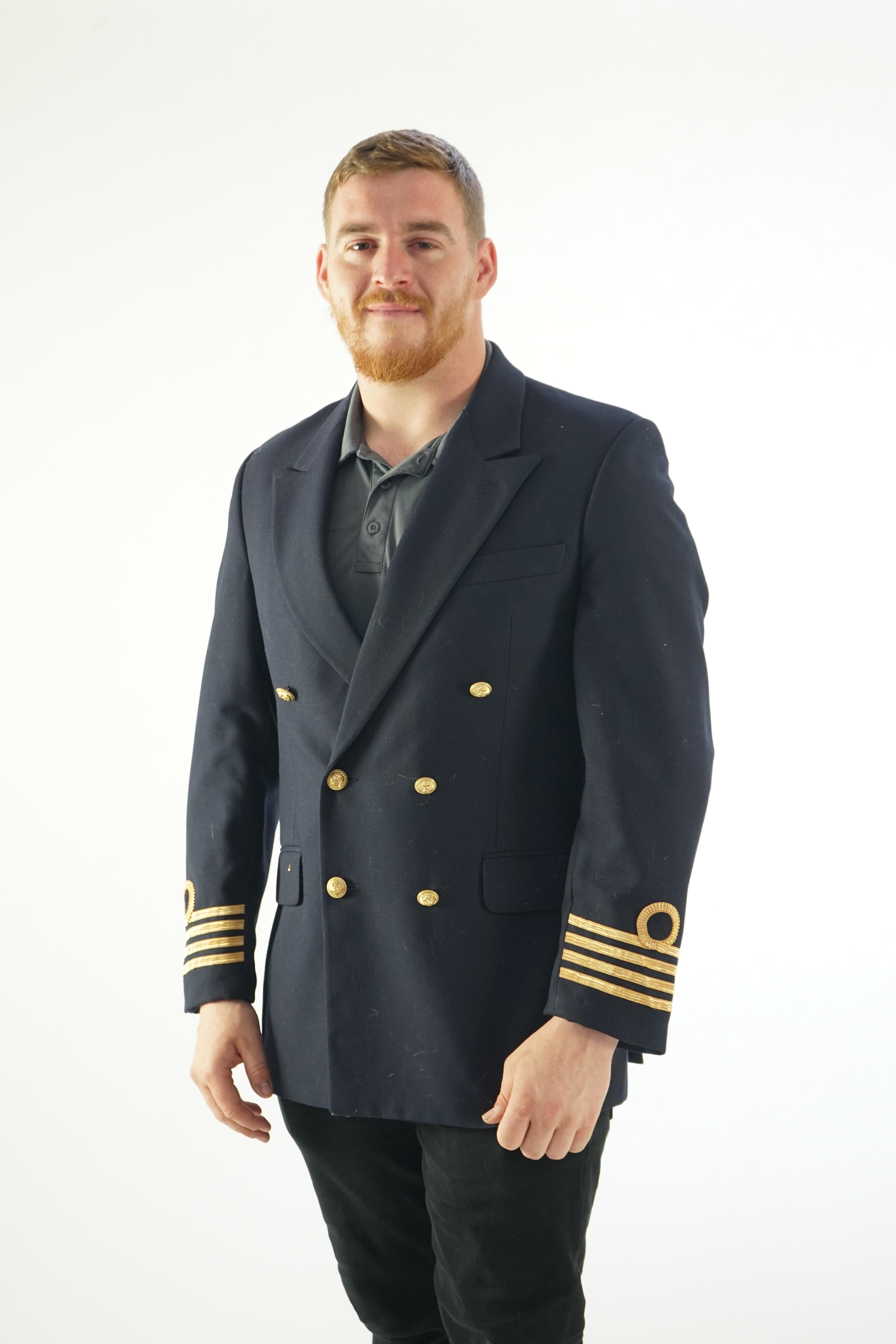 A modern naval style black-navy uniform jacket with gold trim.